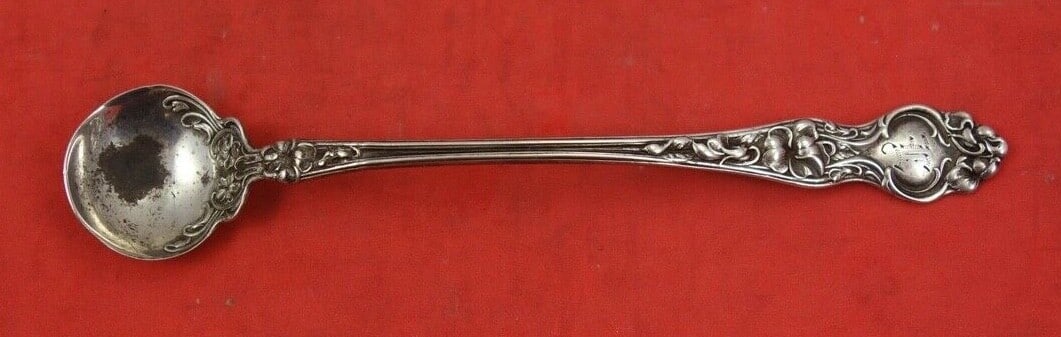 Wallace Violet Sterling Silver Mustard Ladle Fancy Design 4.5": Wallace Violet Sterling Silver Mustard Ladle Fancy Design 4.5" This exquisite mustard ladle, crafted by Wallace in the charming Violet pattern, showcases the elegance of sterling silver. Measuring 4 1