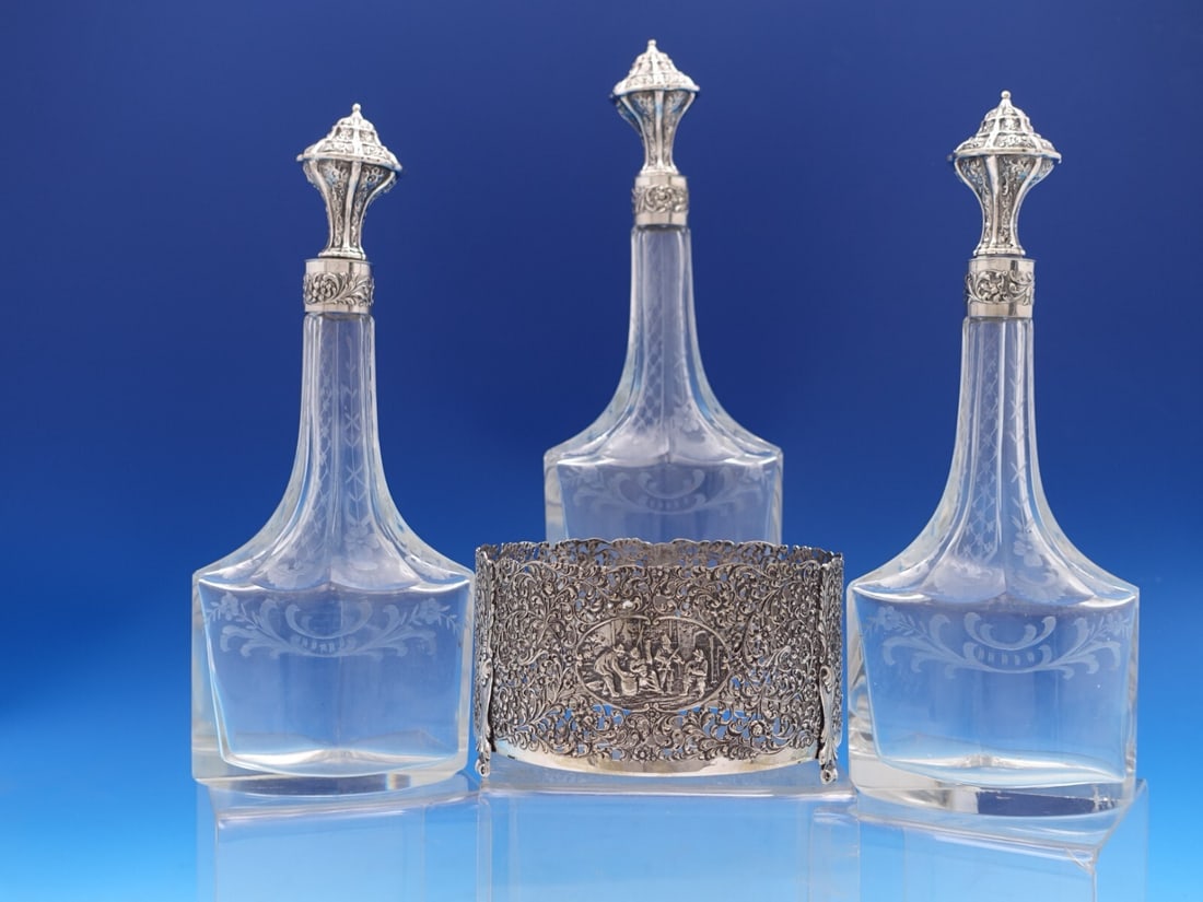 Antique Dutch 830 Silver 3-Piece Liquor Bottle Set with Hand Engraved Glass: Antique Dutch 830 Silver 3-Piece Liquor Bottle Set with Hand Engraved Glass This exquisite 3-piece liquor set showcases the elegance of Dutch craftsmanship from the early to mid-20th century. Made of