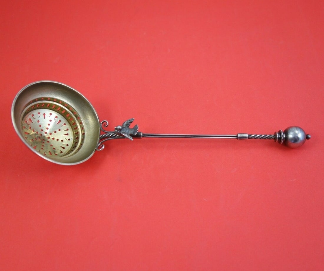Wood & Hughes Sterling Silver Tea Strainer Bird Design 9 Inch: Wood & Hughes Sterling Silver Tea Strainer Bird Design 9 Inch This exquisite tea strainer from Wood & Hughes, crafted between 1850 and 1899, showcases the elegant 'Bird' pattern. Made of high-quality