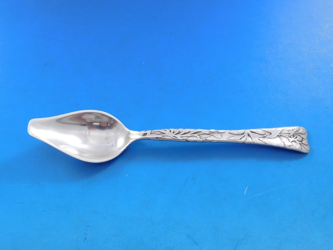 Tiffany Sterling Silver Lap Over Edge Melon Spoon 6 with Flower Motif: Tiffany Sterling Silver Lap Over Edge Melon Spoon 6 with Flower Motif This exquisite 6" melon spoon features the renowned Lap Over Edge pattern by Tiffany & Co., showcasing a beautiful acid-etched flo