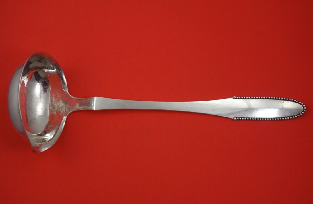 Georg Jensen Sterling Silver Beaded Soup Ladle 14 Inch 1925 Design: Georg Jensen Sterling Silver Beaded Soup Ladle 14 Inch 1925 Design This exquisite soup ladle from Georg Jensen showcases the timeless Beaded pattern, a hallmark of elegance and craftsmanship. Crafted
