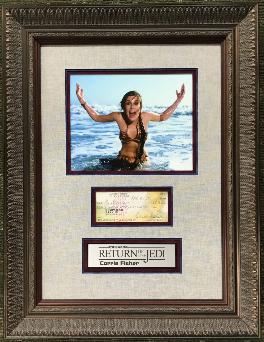 Carrie Fisher Signed Check Star Wars ROTJ Custom Framed Display JSA: Carrie Fisher Signed Check Star Wars ROTJ Custom Framed Display JSA This stunning display features a signed bank check from Carrie Fisher, known for her iconic role as Princess Leia in the Star Wars f