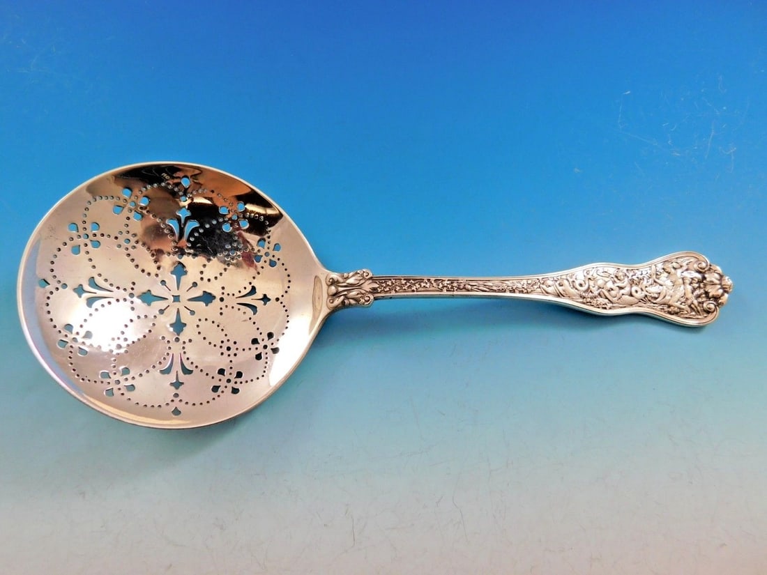 Tiffany & Co Olympian Sterling Silver 9 Inch Pierced Pea Serving Spoon: Tiffany & Co Olympian Sterling Silver 9 Inch Pierced Pea Serving Spoon This exquisite serving spoon is part of the Olympian pattern by Tiffany & Co., introduced in 1878. Crafted from sterling silver,