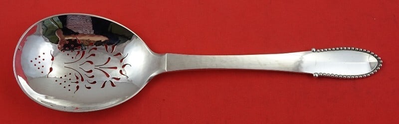 Georg Jensen Beaded Sterling Silver 9 Inch Slotted Spoon: Georg Jensen Beaded Sterling Silver 9 Inch Slotted Spoon This exquisite 9" slotted spoon, designed by Georg Jensen, features the elegant Beaded pattern. Crafted from high-quality sterling silver, this