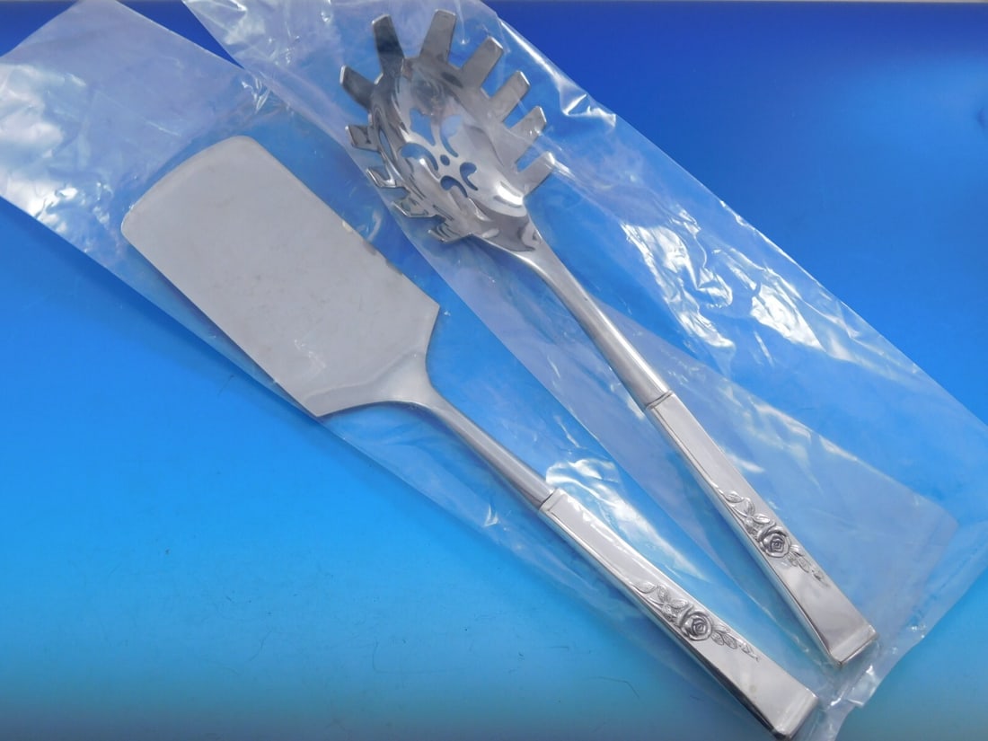 Reed and Barton Classic Rose Sterling Silver Pasta Set 2pc: Reed and Barton Classic Rose Sterling Silver Pasta Set 2pc Elevate your dining experience with this exquisite Classic Rose Hostess Set by Reed and Barton. Crafted from high-quality sterling silver, th