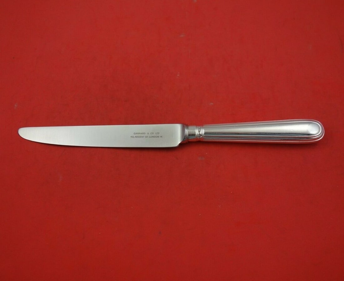 CJ Vander Thread Sterling Silver Dinner Knife 9 7/8" Made for Garrard: CJ Vander Thread Sterling Silver Dinner Knife 9 7/8" Made for Garrard This exquisite dinner knife is crafted from sterling silver with a hollow handle, showcasing the elegant Thread pattern by CJ Vand