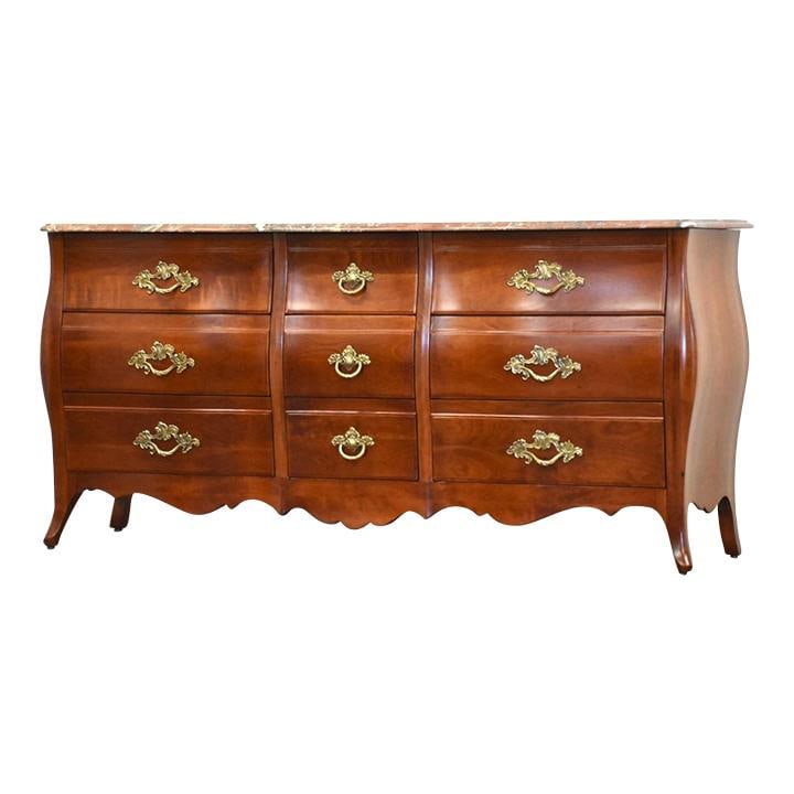 1960s John Widdicomb French Provincial Bombe Cherry Dresser: 1960s John Widdicomb French Provincial Bombe Cherry Dresser This exquisite French Provincial Bombe style dresser, crafted by John Widdicomb in the 1960s, features a stunning marble top and is construc