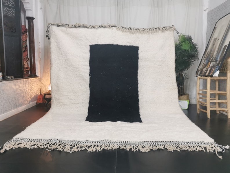 Handmade Moroccan Berber Wool Rug 9.84 x 6.56 Feet: Handmade Moroccan Berber Wool Rug 9.84 x 6.56 Feet Enhance your living space with this exquisite Soft Black & White Handmade Moroccan Berber Wool Rug. This stunning piece is handwoven by local Berber
