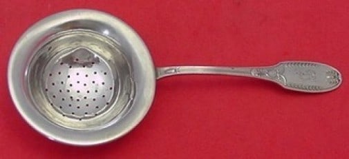 Alvin Marie Antoinette Sterling Silver 6 Inch Tea Strainer: Alvin Marie Antoinette Sterling Silver 6 Inch Tea Strainer Indulge in the elegance of the Marie Antoinette tea strainer by Alvin, a stunning serving piece crafted from sterling silver. This 6" flat ha