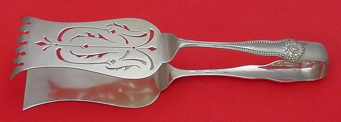 Lexington Sterling Silver Asparagus Tong by Knowles 9 5/8": Lexington Sterling Silver Asparagus Tong by Knowles 9 5/8" Presenting the Lexington Asparagus Tong from Knowles, crafted in exquisite sterling silver. This serving piece features a pierced design and
