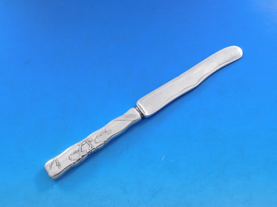 Tiffany & Co. Lap Over Edge Sterling Silver Dessert Knife with Birds Motif: Tiffany & Co. Lap Over Edge Sterling Silver Dessert Knife with Birds Motif This exquisite dessert knife features the iconic Lap Over Edge design, crafted by Tiffany & Co. Made from high-quality sterli