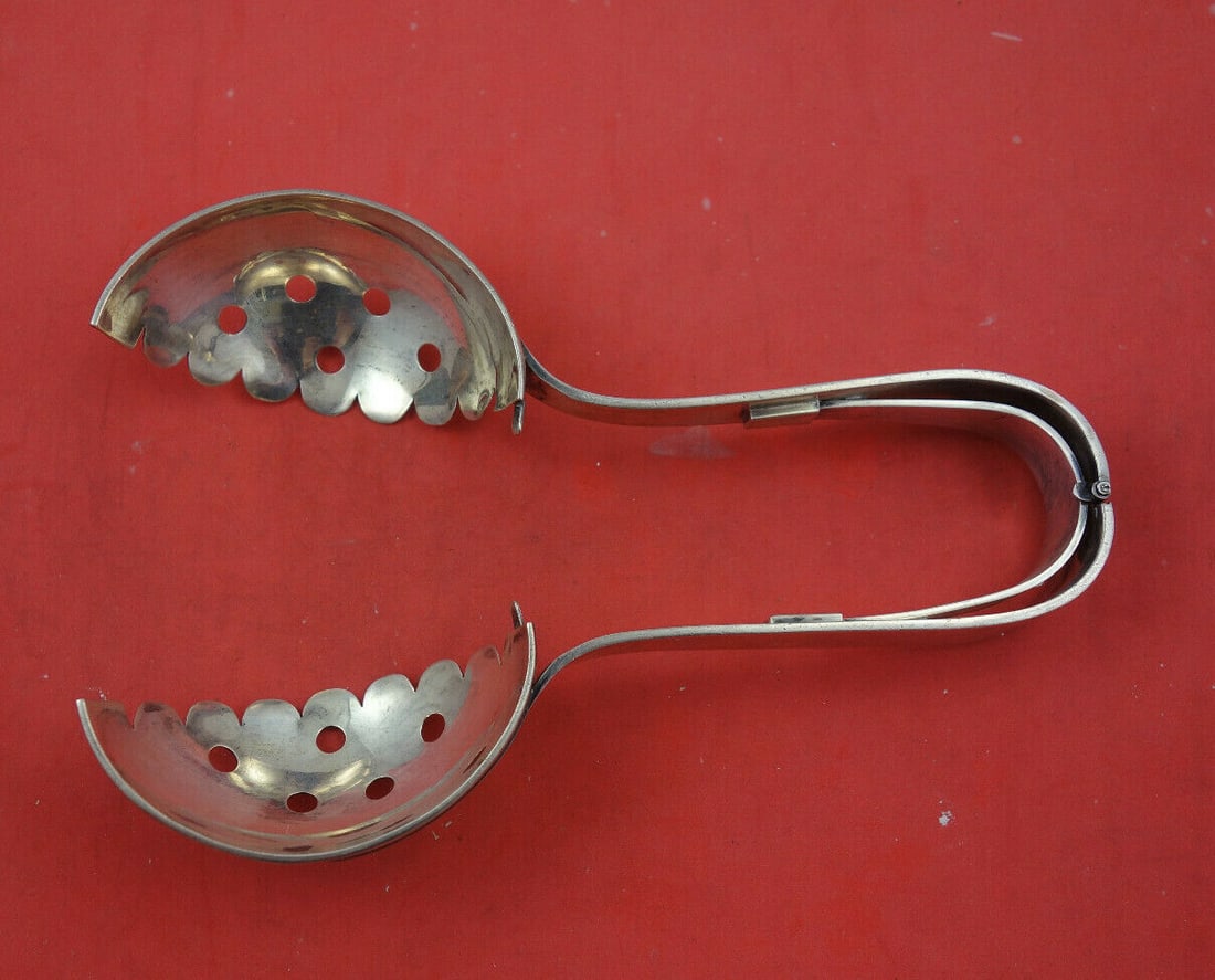 Dieges & Clust Sterling Silver 7 Inch Hand Wrought Ice Tong Strainer: Dieges & Clust Sterling Silver 7 Inch Hand Wrought Ice Tong Strainer This exquisite 7-inch ice tong strainer is hand wrought from sterling silver by Dieges & Clust, showcasing a unique mechanical hing