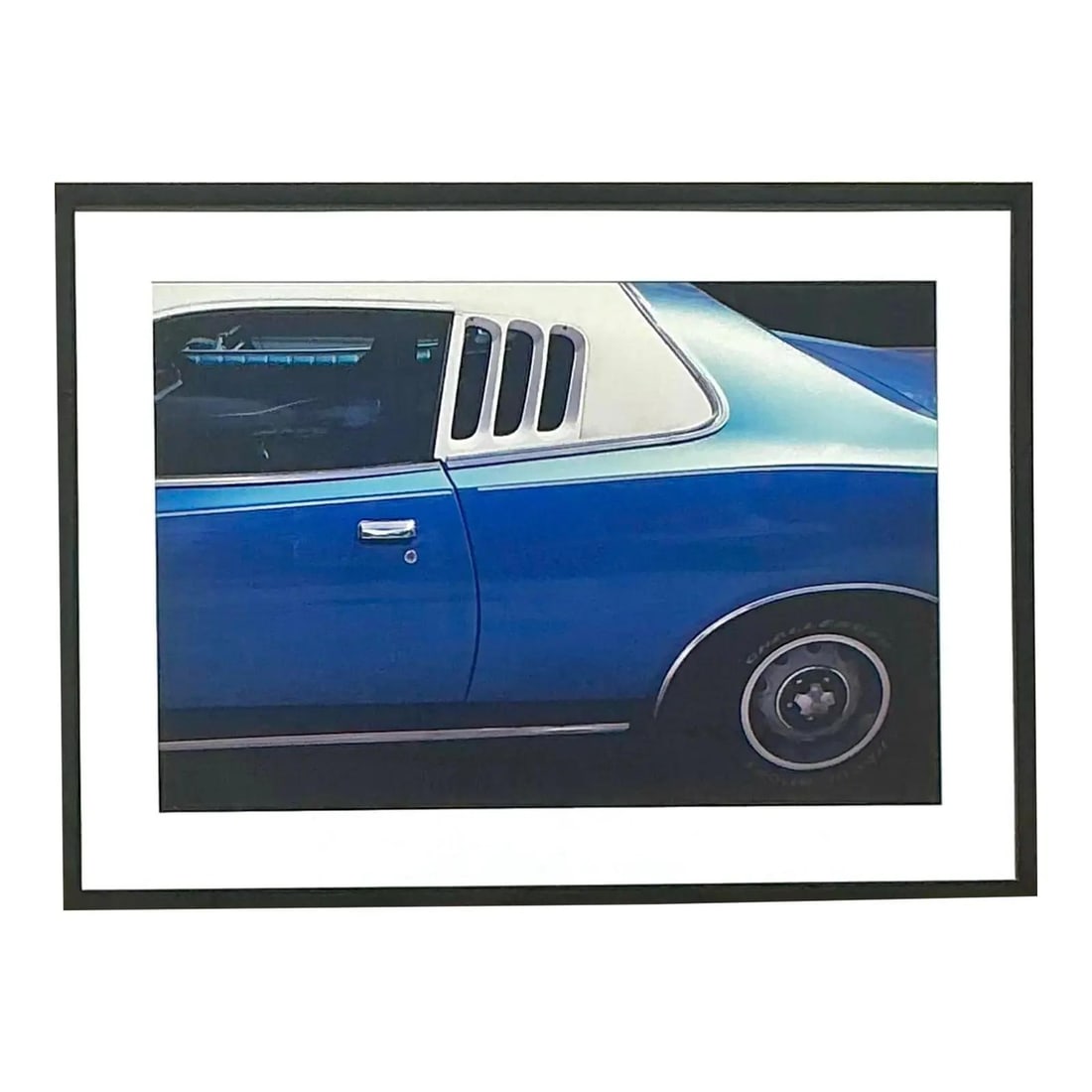 Framed Blue Muscle Car Photographic Art Print with Black Frame: Framed Blue Muscle Car Photographic Art Print with Black Frame This bold photographic print features a vintage blue muscle car, captured in a sleek side view that emphasizes its distinctive curves, ch
