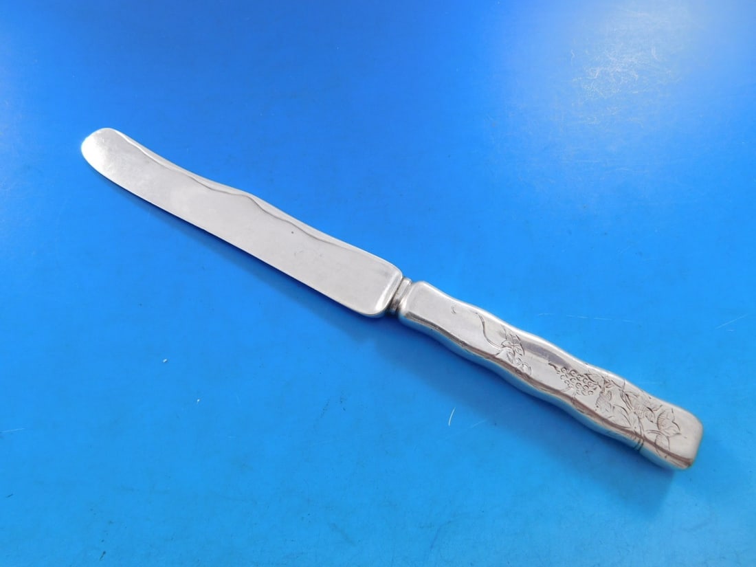 Tiffany Sterling Silver Dessert Knife Lap Over Edge Grapes Vines 7.5": Tiffany Sterling Silver Dessert Knife Lap Over Edge Grapes Vines 7.5" This exquisite dessert knife features the Lap Over Edge pattern by Tiffany & Co., crafted from high-quality sterling silver. The k