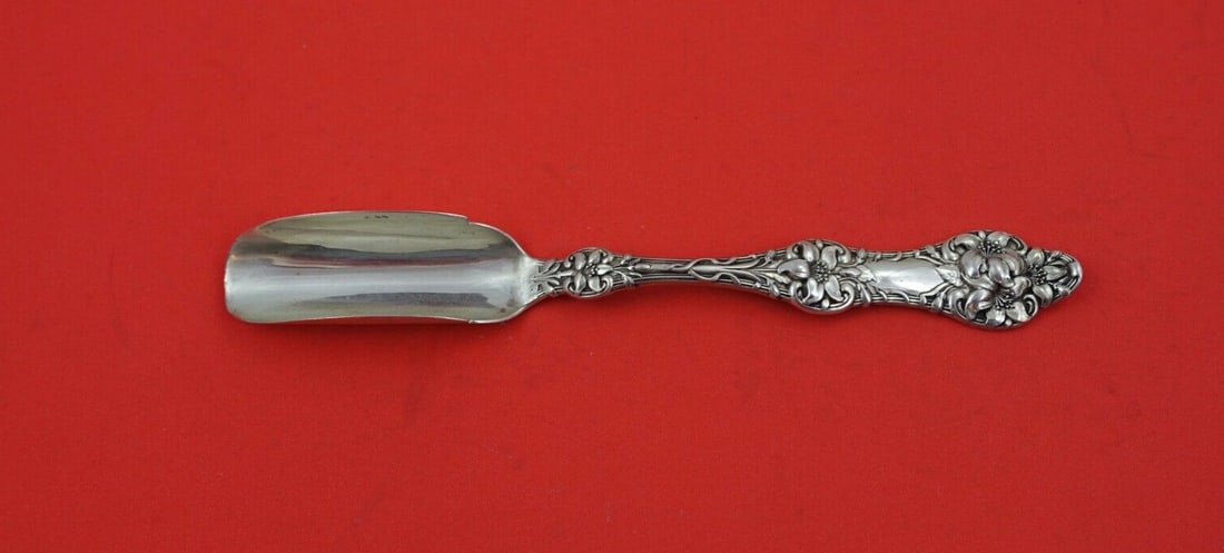 Alvin Gorham Old Orange Blossom Sterling Cheese Scoop 7.5": Alvin Gorham Old Orange Blossom Sterling Cheese Scoop 7.5" This exquisite cheese scoop is crafted from sterling silver in the elegant Old Orange Blossom pattern by Alvin, made by Gorham. Measuring 7 1