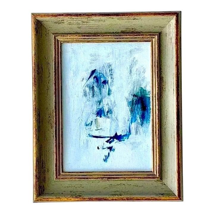 Framed Abstract Oil Artwork on Masonite with Rustic Boho Appeal: Framed Abstract Oil Artwork on Masonite with Rustic Boho Appeal This vintage boho abstract oil painting features soft blue strokes on a pale background, creating a tranquil and airy composition. The a