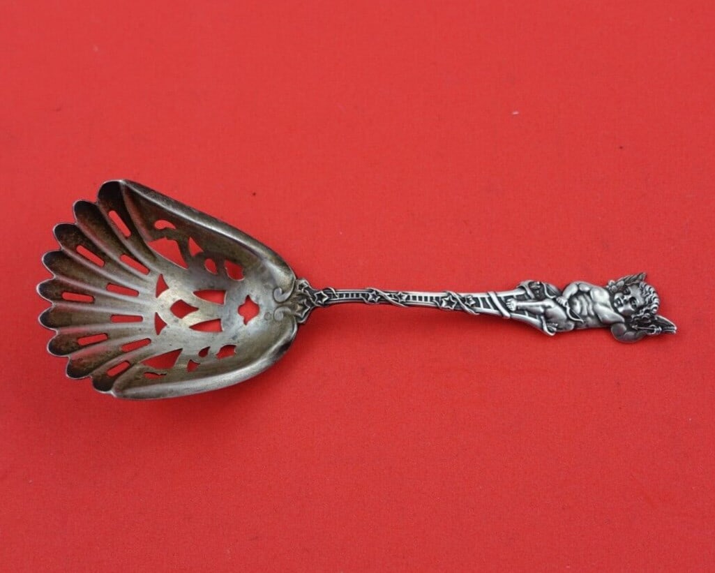 Watson Sterling Silver 4 3/4" Almond Scoop with Winged Cherub: Watson Sterling Silver 4 3/4" Almond Scoop with Winged Cherub This exquisite almond scoop is crafted from sterling silver and features a charming figural design with a winged cherub. Measuring 4 3/4 i