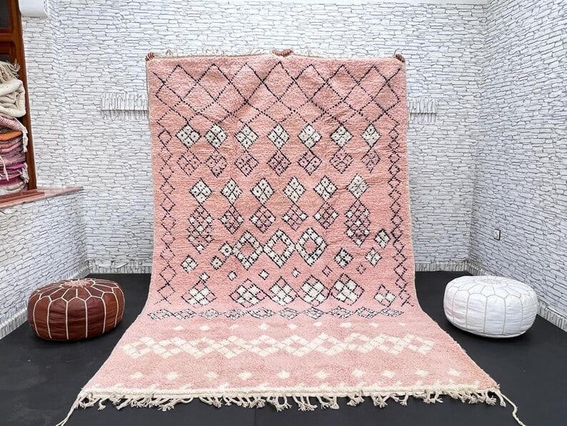 Authentic Handwoven Soft Pink Wool Rug 8 x 5 Feet Morocco: Authentic Handwoven Soft Pink Wool Rug 8 x 5 Feet Morocco Experience the charm of authentic craftsmanship with this Elegant Soft Pink Wool Rug. Handwoven in the Atlas Mountains by skilled Berber women