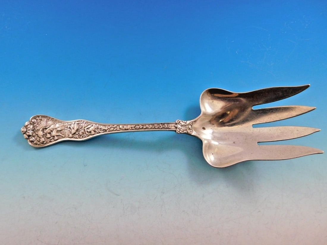 Tiffany & Co Olympian Sterling Silver Fish Serving Fork 9.5in 4 Tines: Tiffany & Co Olympian Sterling Silver Fish Serving Fork 9.5in 4 Tines Experience the elegance of the Olympian pattern with this exquisite sterling silver fish serving fork by Tiffany & Co. Measuring 9