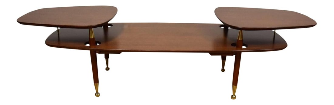 Italian 2-Tiered Mahogany Coffee Table with Brass Accents: Italian 2-Tiered Mahogany Coffee Table with Brass Accents This exquisite 2-tiered coffee table features a unique Italian design crafted from rich mahogany with a walnut color finish. The table is supp