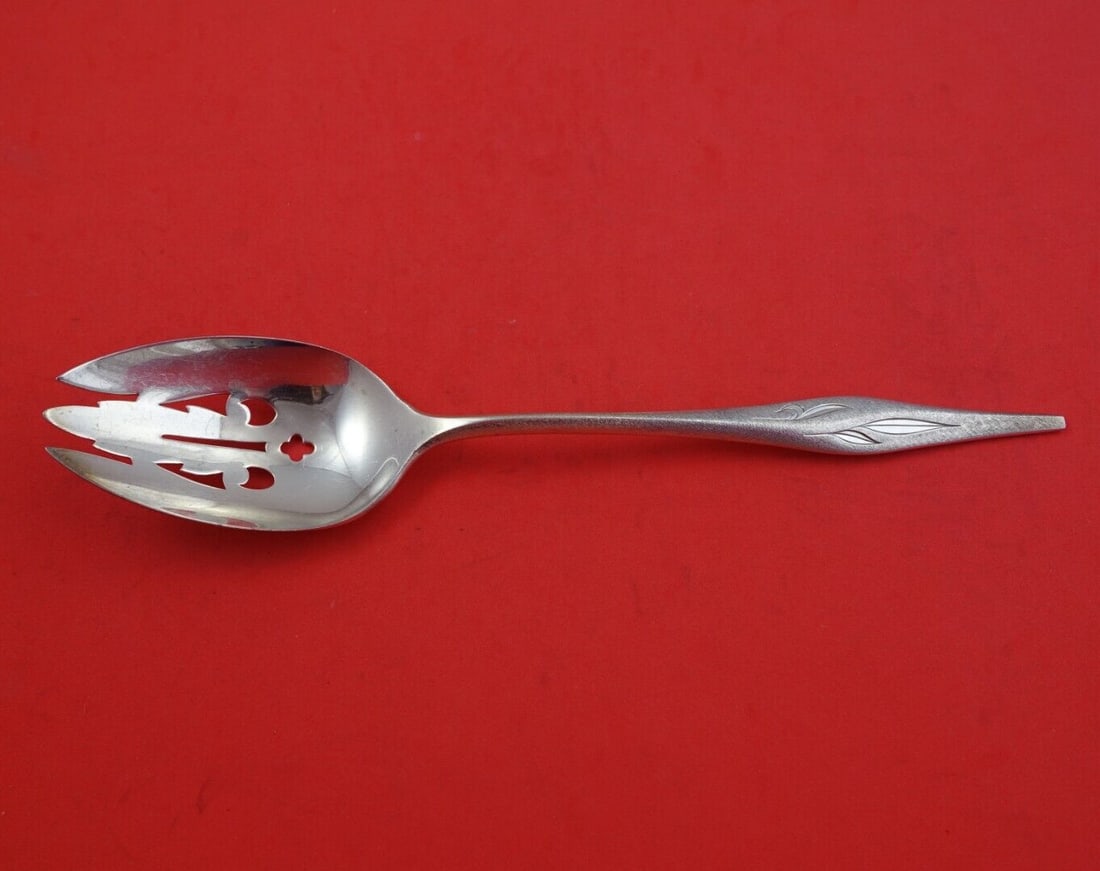 Wallace Still Mood Sterling Silver 9 Inch Slotted Serving Spoon: Wallace Still Mood Sterling Silver 9 Inch Slotted Serving Spoon Experience the timeless elegance of the "Still Mood" pattern with this exquisite Sterling Silver serving spoon by Wallace. Measuring 9 i
