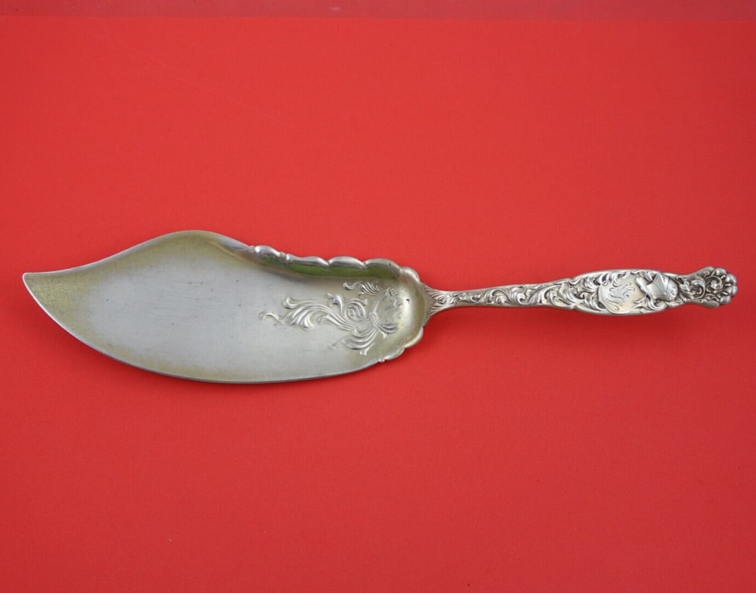 Whiting Heraldic Sterling Silver Fish Server Fancy Blade 12 3/8 in: Whiting Heraldic Sterling Silver Fish Server Fancy Blade 12 3/8 in This exquisite fish server from the Heraldic pattern by Whiting is crafted in high-quality sterling silver. Featuring a fancy blade d