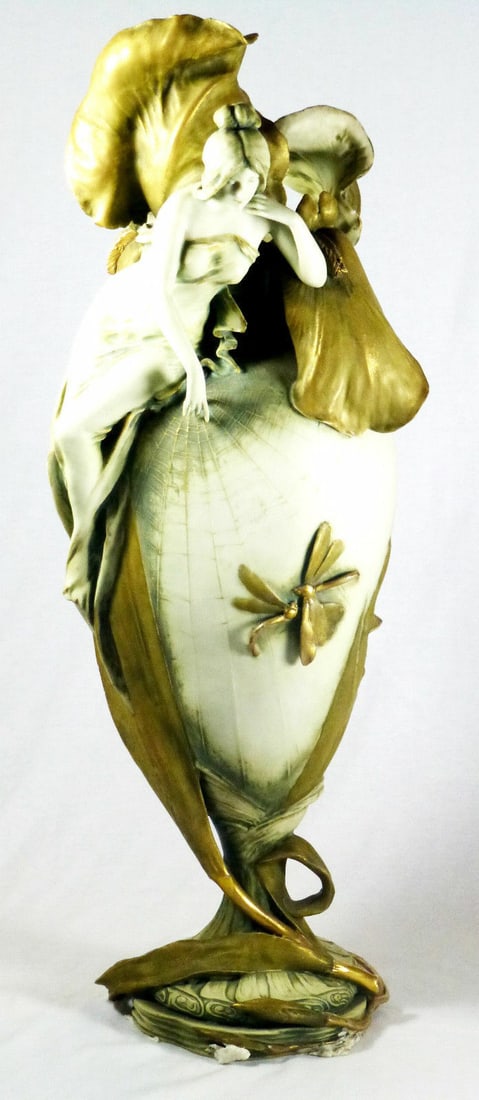 Antique Art Nouveau Amphora Porcelain Vase Circa 1910 Gilt Figures: Antique Art Nouveau Amphora Porcelain Vase Circa 1910 Gilt Figures This exquisite Art Nouveau Amphora vase, crafted around 1910, showcases a stunning design in white and gold. Made from high-quality p