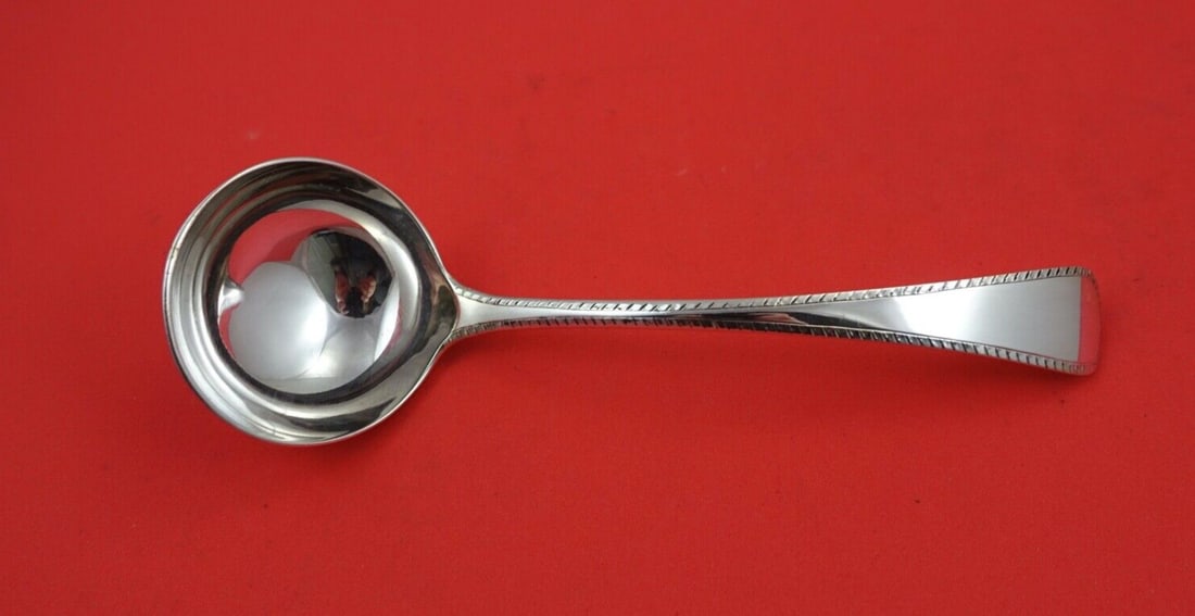 James Robinson Feather Edge Sterling Silver Gravy Ladle 7 3/8 Inches: James Robinson Feather Edge Sterling Silver Gravy Ladle 7 3/8 Inches This exquisite gravy ladle features the elegant Feather Edge pattern by James Robinson, crafted from high-quality sterling silver.