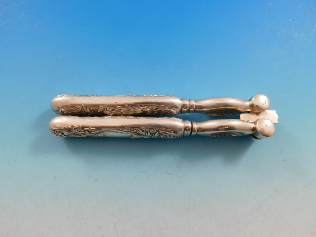 Tiffany & Co Chrysanthemum Sterling Silver Nut Cracker 5 1/2": Tiffany & Co Chrysanthemum Sterling Silver Nut Cracker 5 1/2" Introducing the exquisite Chrysanthemum Nut Cracker by Tiffany & Co., a stunning piece crafted from high-quality sterling silver. This uni