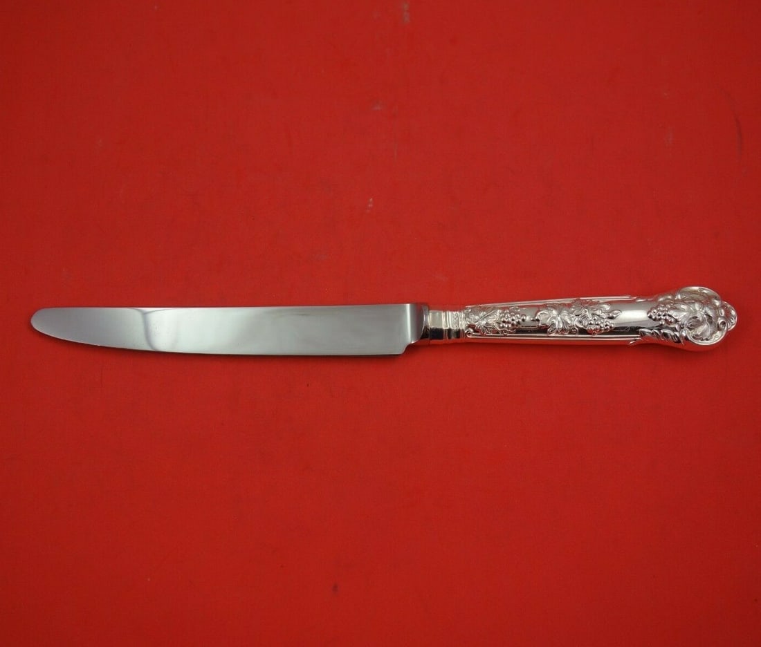 Edward Barnard Sterling Silver Dinner Knife Grapes and Vine 10": Edward Barnard Sterling Silver Dinner Knife Grapes and Vine 10" Elevate your dining experience with this exquisite Sterling Silver Dinner Knife from Edward Barnard & Sons. Featuring the elegant 'Grape