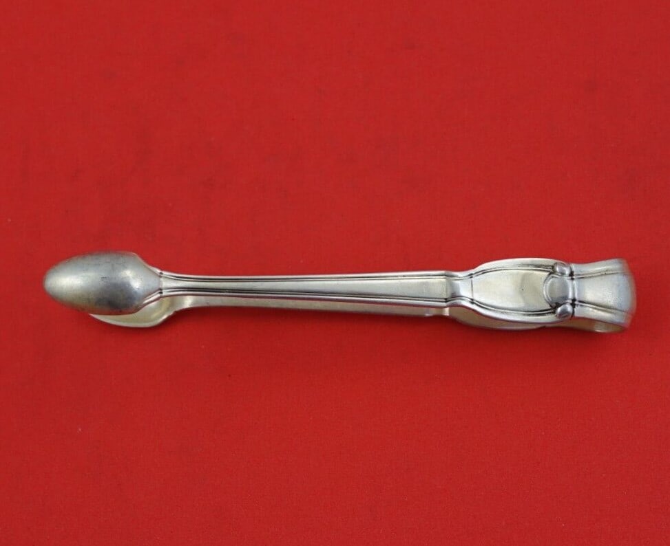 Tiffany & Co Castilian Sterling Silver Sugar Tong Serving Piece 4 1/4": Tiffany & Co Castilian Sterling Silver Sugar Tong Serving Piece 4 1/4" This exquisite sugar tong from Tiffany & Co. features the elegant Castilian pattern, a classic design perfect for serving sugar a