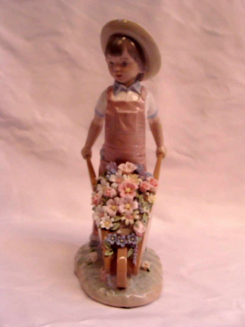 Lladro Porcelain Figurine Boy with Flowers 9.5 Inches: Lladro Porcelain Figurine Boy with Flowers 9.5 Inches Discover the exquisite beauty of this Lladro figurine, featuring a charming boy carrying a bouquet of flowers. Crafted from fine Spanish porcelain
