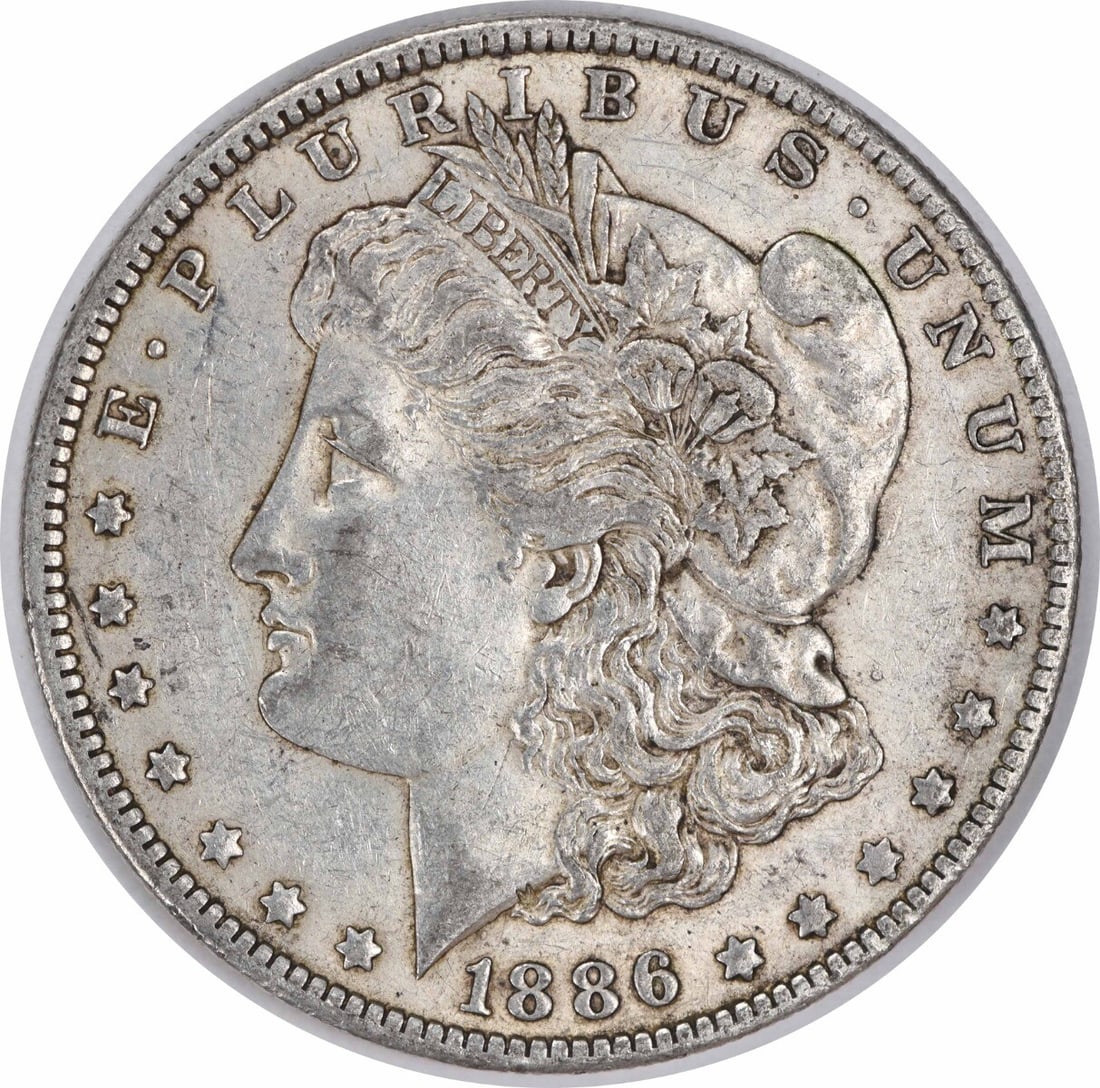1886-O Morgan Silver Dollar 90% Silver Uncertified New Orleans: 1886-O Morgan Silver Dollar 90% Silver Uncertified New Orleans This 1886-O Morgan Silver Dollar is a classic piece of American numismatics, showcasing intricate design elements by George T. Morgan. Th