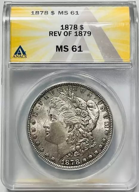 1878 Morgan Silver Dollar ANACS MS61 Uncirculated Silver Coin: 1878 Morgan Silver Dollar ANACS MS61 Uncirculated Silver Coin This 1878 Morgan Silver Dollar is certified by ANACS with a grade of MS 61, indicating it is in uncirculated condition. This historic coin