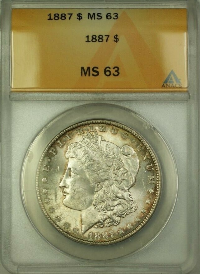 ANACS MS-63 1887 Morgan Dollar Silver Coin with Rim Toning: ANACS MS-63 1887 Morgan Dollar Silver Coin with Rim Toning This 1887 Morgan Silver Dollar was minted in Philadelphia and features rim toning. The coin is certified by ANACS with an MS-63 grade, indica