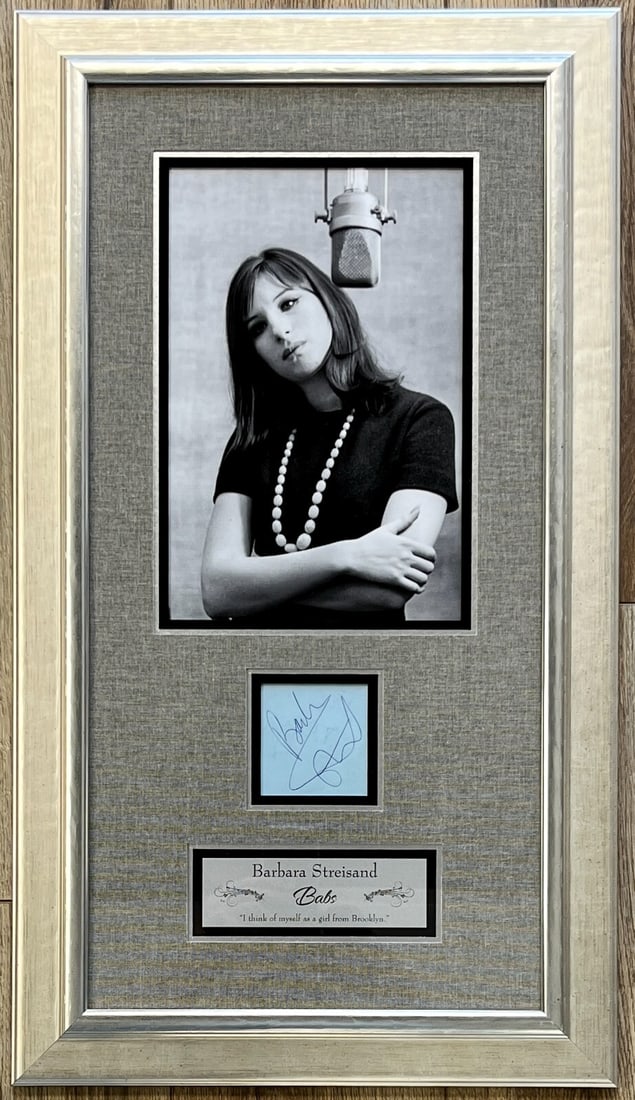 Barbara Streisand Full Name Signature Custom Framed JSA Authenticated Display: Barbara Streisand Full Name Signature Custom Framed JSA Authenticated Display This exquisite display features a rare full name signature of the iconic singing legend Barbara Streisand. The cut signatu