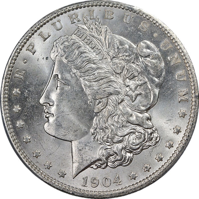 1904-O Morgan Silver Dollar PCGS MS63 VAM 4B Blast White Coin: 1904-O Morgan Silver Dollar PCGS MS63 VAM 4B Blast White Coin This stunning 1904-O Morgan Silver Dollar is graded MS63 by PCGS, showcasing outstanding eye appeal with magnificent luster and a strong s