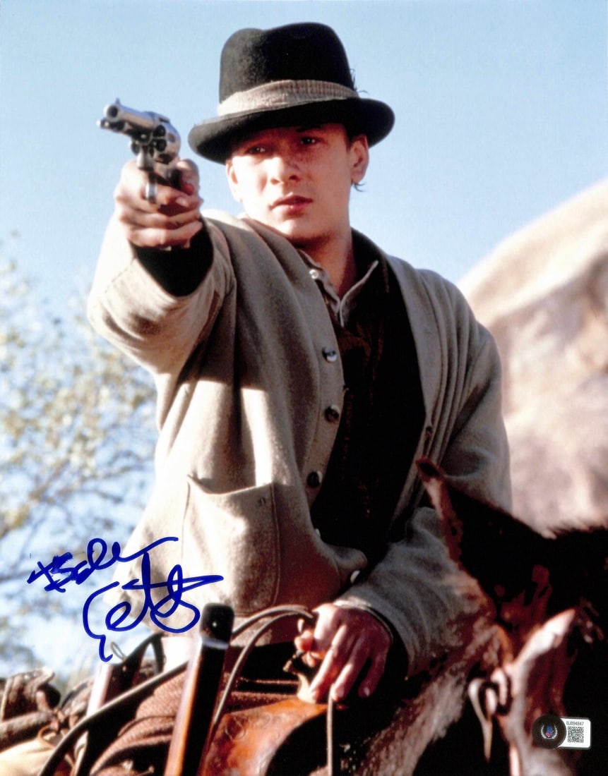 Balthazar Getty Signed Young Guns II 11x14 Photo Beckett Certified: Balthazar Getty Signed Young Guns II 11x14 Photo Beckett Certified This autographed 11x14 photograph features Balthazar Getty, known for his role as Tom O'Folliard in the film Young Guns II. The signa