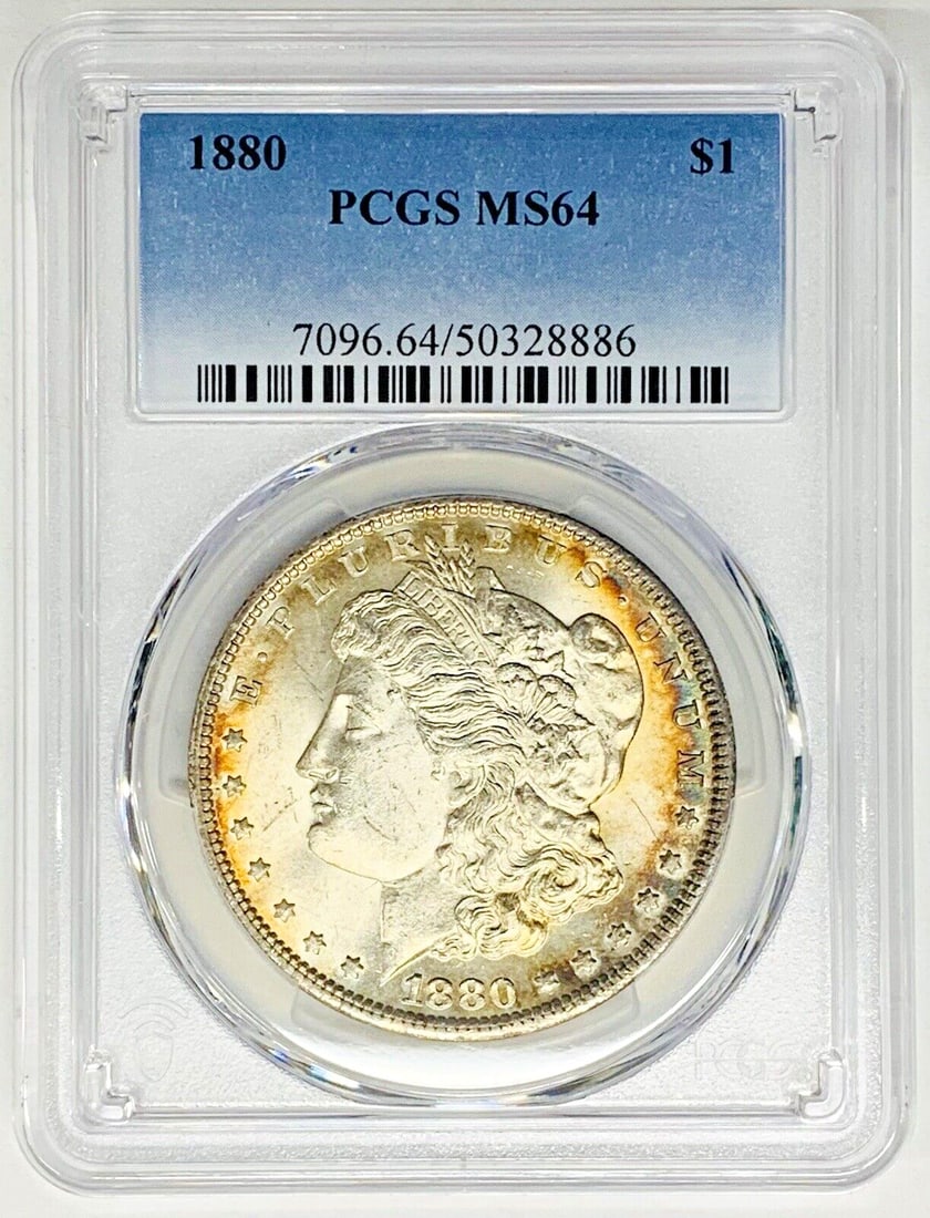 PCGS MS64 Morgan Silver Dollar 1880 with Peripheral Toning: PCGS MS64 Morgan Silver Dollar 1880 with Peripheral Toning This 1880 Morgan Silver Dollar features a peripheral tone and is graded MS 64 by PCGS. The coin is composed of silver and remains uncirculate