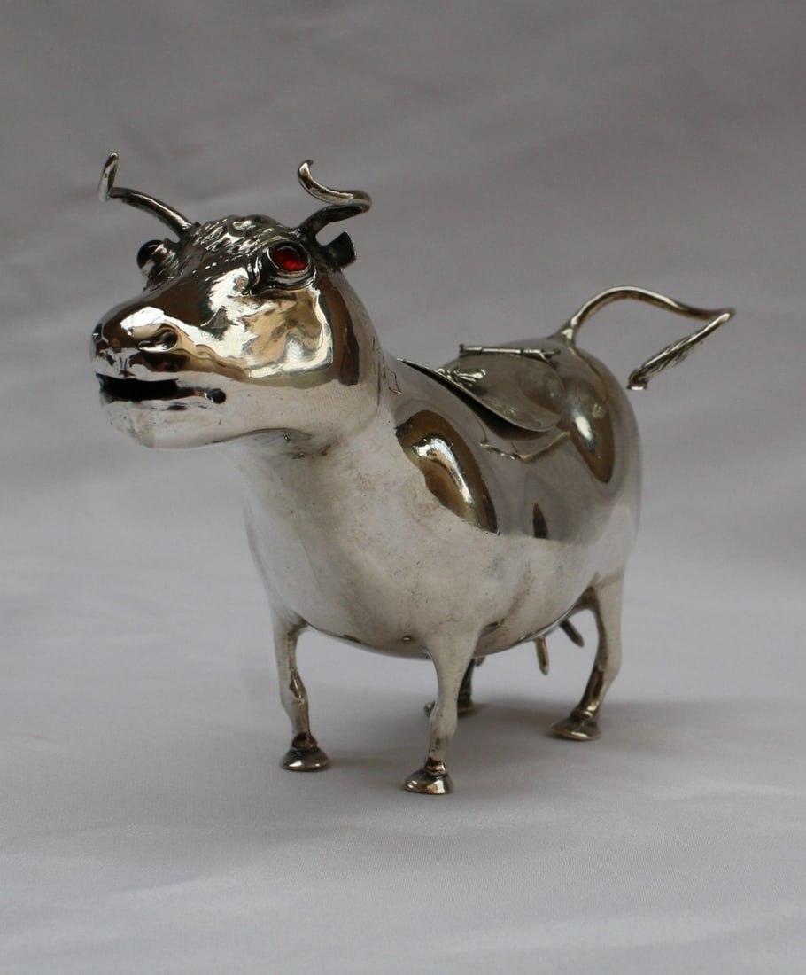 18th Century Dutch Sterling Silver Creamer with Garnet Eyes: 18th Century Dutch Sterling Silver Creamer with Garnet Eyes This exquisite 18th-century Dutch sterling silver creamer showcases remarkable craftsmanship and a stunning design. The creamer features int