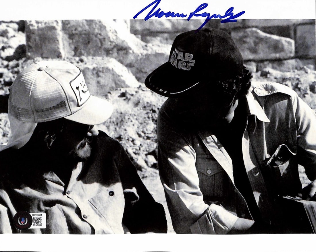 Norman Reynolds Signed 8x10 Indiana Jones Photo Beckett Authenticated: Norman Reynolds Signed 8x10 Indiana Jones Photo Beckett Authenticated This rare 8x10 behind-the-scenes photograph from Indiana Jones is signed boldly in blue by legendary production designer Norman Re