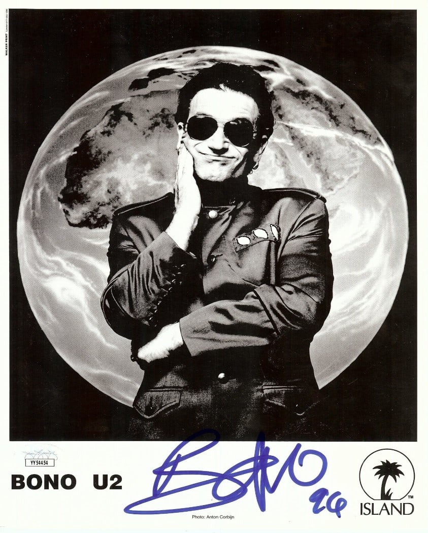 Bono Autographed 8X10 Photo U2 JSA Certified: Bono Autographed 8X10 Photo U2 JSA Certified This is an original 8x10 photograph of Bono, the iconic lead singer of U2, featuring his authentic signature. The autograph has been verified and authentic
