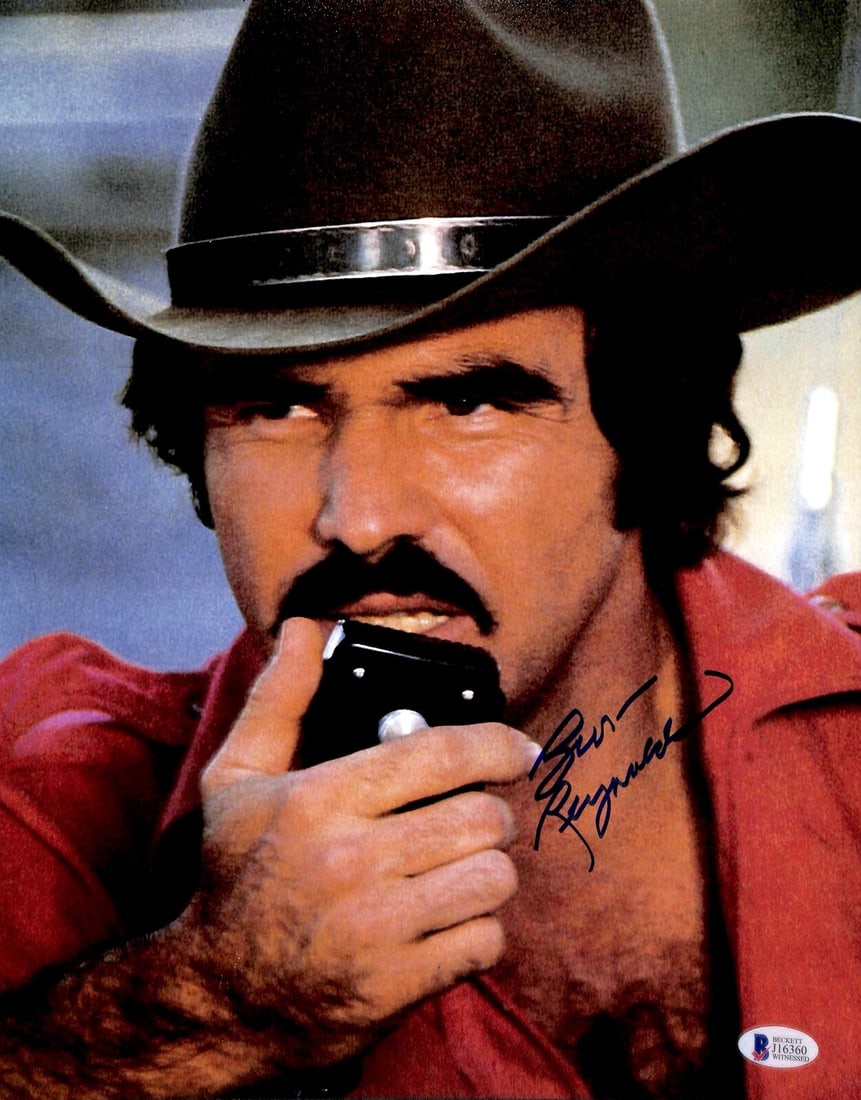 11x14 Photo Autographed by Burt Reynolds Beckett Certified Witnessed: 11x14 Photo Autographed by Burt Reynolds Beckett Certified Witnessed This is an 11x14 photograph autographed by Burt Reynolds, known for his role in the movie Smokey and the Bandit. The signature is e