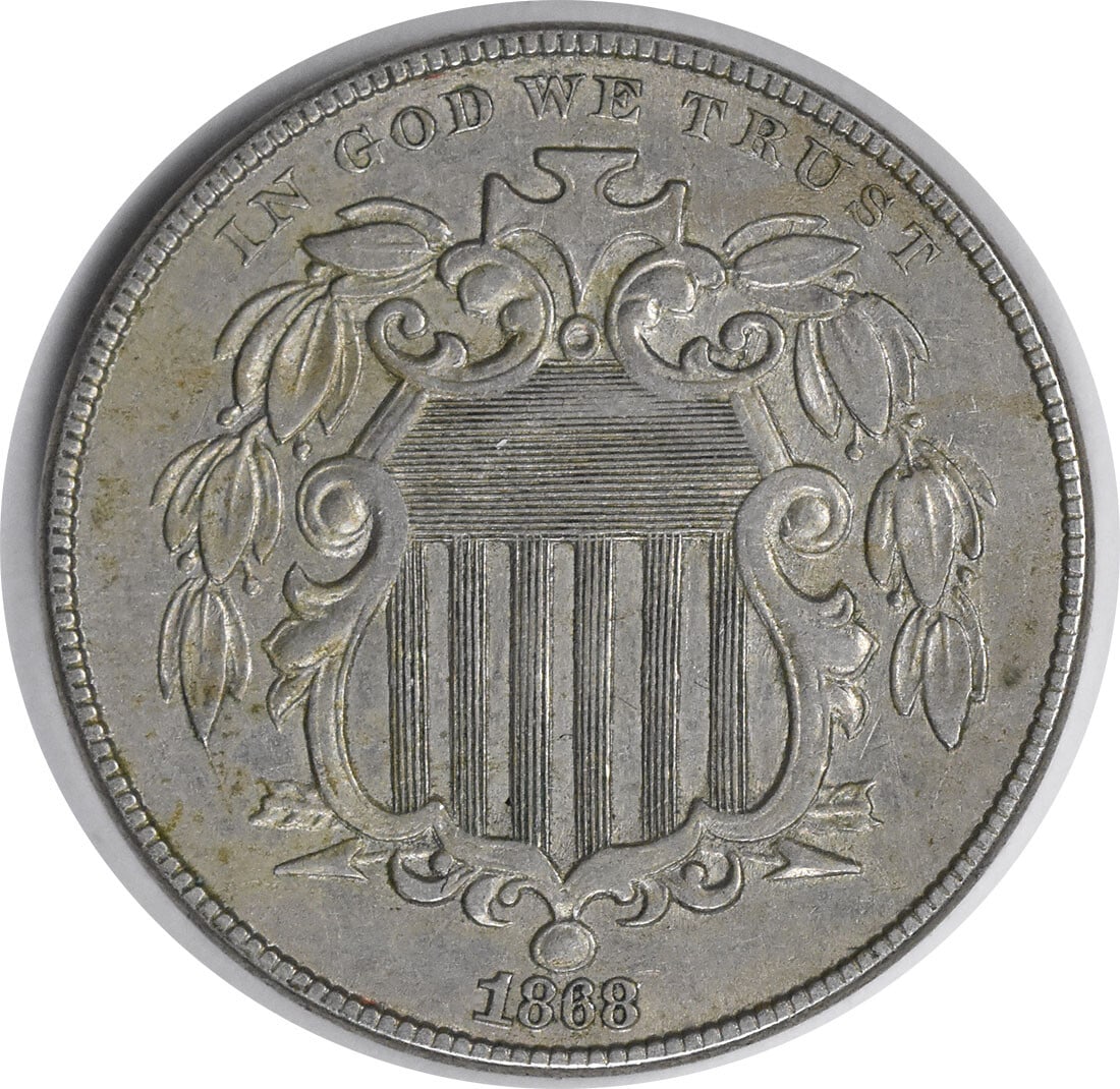 1868 Shield Nickel AU Uncertified 5C by Longacre Philadelphia: 1868 Shield Nickel AU Uncertified 5C by Longacre Philadelphia This 1868 Shield Nickel is a remarkable piece for collectors, featuring a design by James Barton Longacre. It is classified as AU (About U