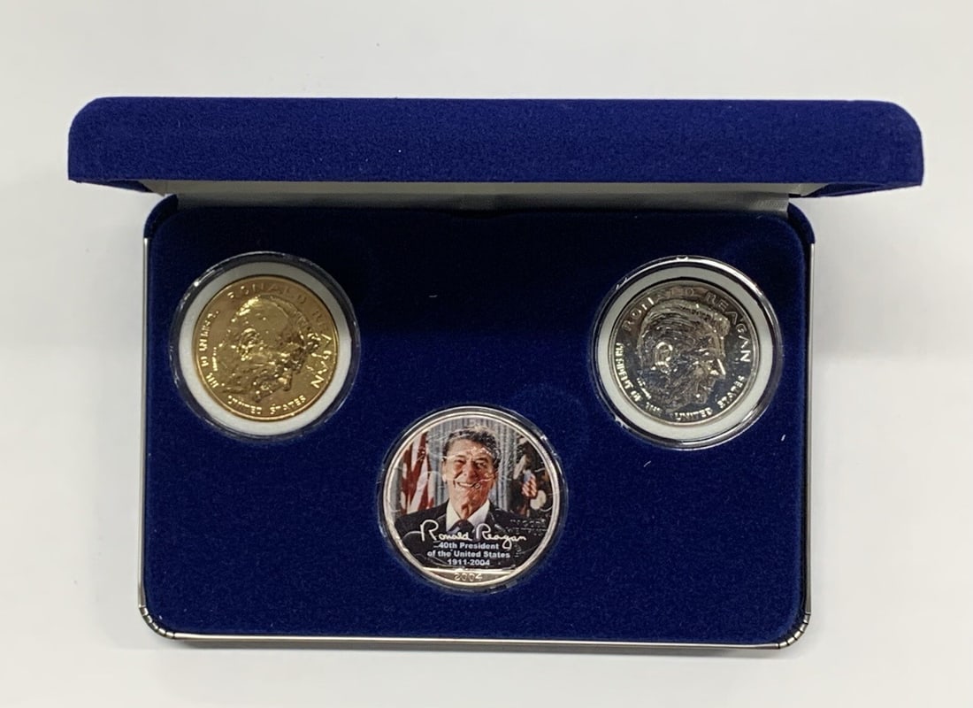 Colorized 2004 Silver Eagle Ronald Reagan with Two Medals Box and COA Set: Colorized 2004 Silver Eagle Ronald Reagan with Two Medals Box and COA Set This set includes a 2004 Silver $1 Eagle coin featuring a colorized image of Ronald Reagan, accompanied by two medals. The set