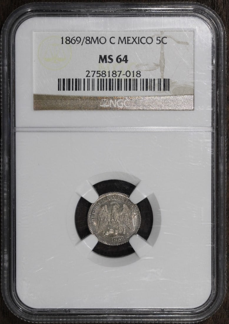1869 Mexico 5 Centavo MS64 NGC Clear Overdate Silver Coin: 1869 Mexico 5 Centavo MS64 NGC Clear Overdate Silver Coin This 1869 Mexico 5 Centavo coin is an exceptional piece from the Second Republic (1867-1905), showcasing a clear overdate. With a grade of MS