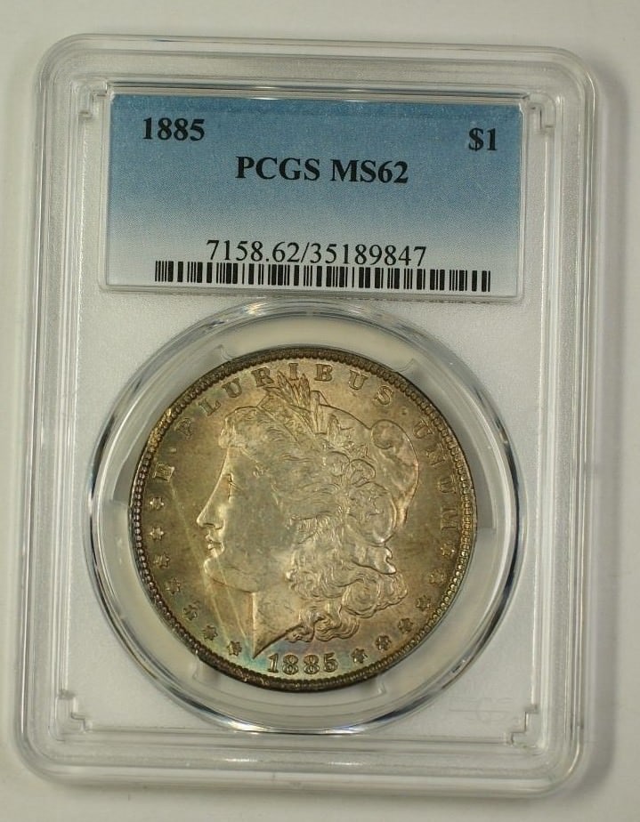 PCGS MS-62 1885 Morgan Dollar Silver $1 Coin Toned: PCGS MS-62 1885 Morgan Dollar Silver $1 Coin Toned This is an 1885 Morgan Silver Dollar coin graded MS-62 by PCGS. The coin is uncirculated and features a toned appearance. It is composed of silver an