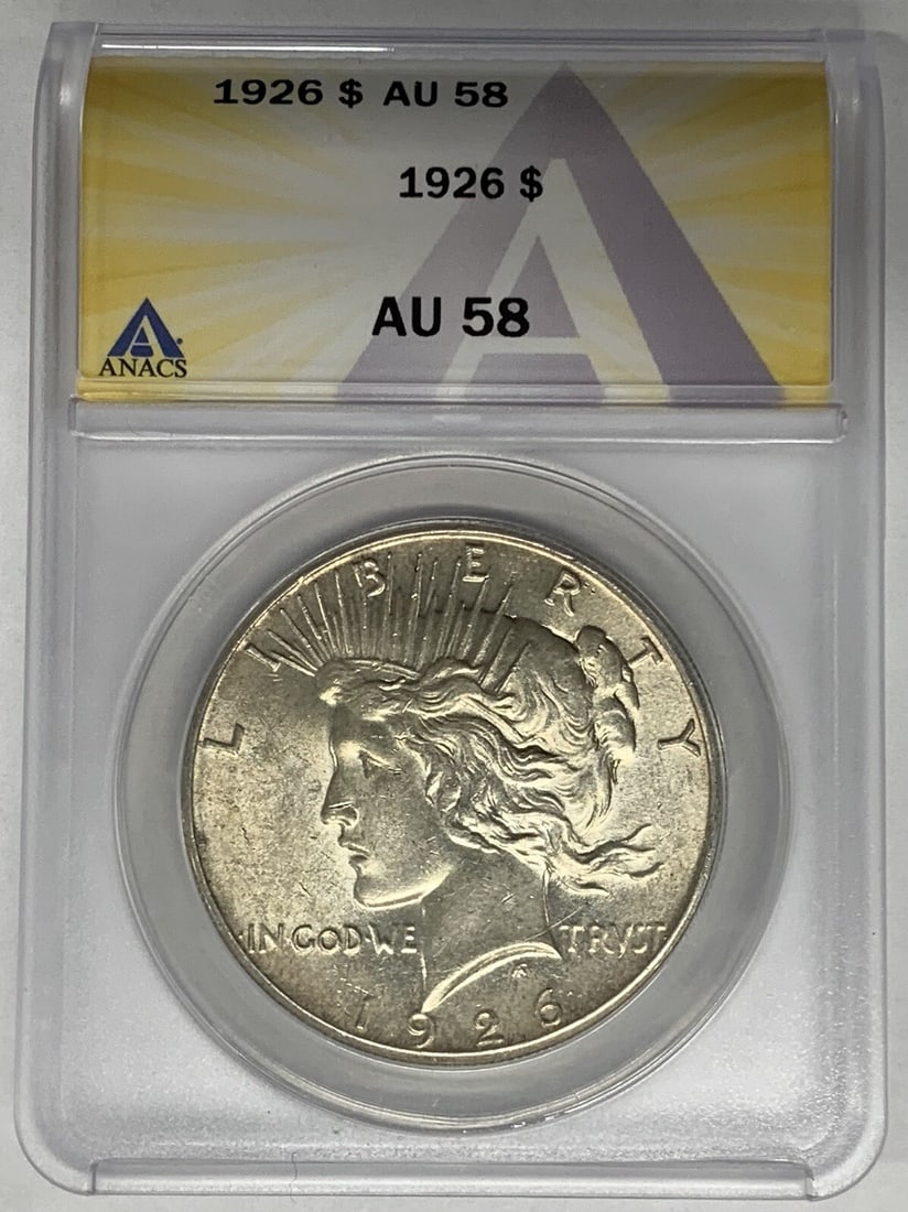 1926 Peace Dollar Silver Coin Graded AU 58 by ANACS: 1926 Peace Dollar Silver Coin Graded AU 58 by ANACS This 1926 Peace Silver Dollar is a $1 coin from the United States, composed of silver. Graded AU 58 by ANACS, it is a circulated coin that remains i