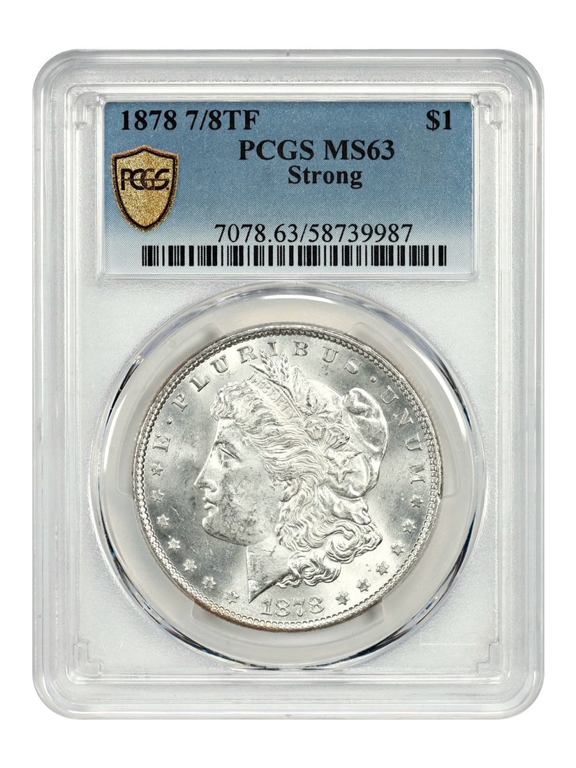 PCGS MS63 1878 7 Over 8 Tail Feathers Morgan Dollar Popular Variety: PCGS MS63 1878 7 Over 8 Tail Feathers Morgan Dollar Popular Variety This 1878 7/8 Tail Feathers Morgan Dollar is a popular variety, graded MS63 (Mint State 63) by PCGS. It is uncirculated and was stru