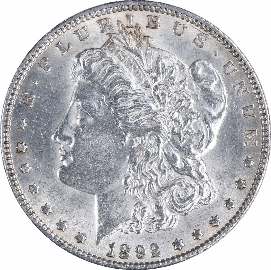 1892 Morgan Silver Dollar AU Uncertified 90% Silver Coin: 1892 Morgan Silver Dollar AU Uncertified 90% Silver Coin This 1892 Morgan Silver Dollar is a remarkable piece for collectors. With an AU grade, this coin showcases the classic design by George T. Morg